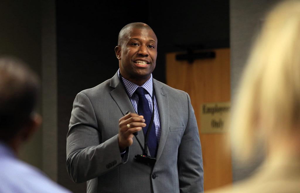 Photo of Shawn Williams presenting his research at the 16th annual Doctoral Research Symposium on the Twin Cities Campus of Saint Mary’s University of Minnesota.